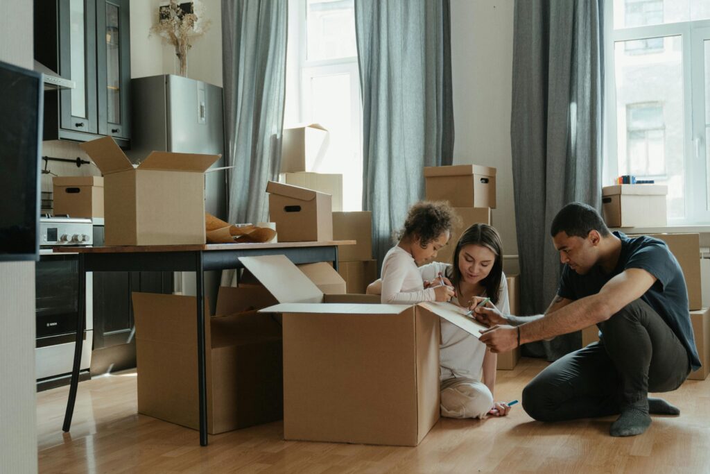 family unpacking boxes in their new home