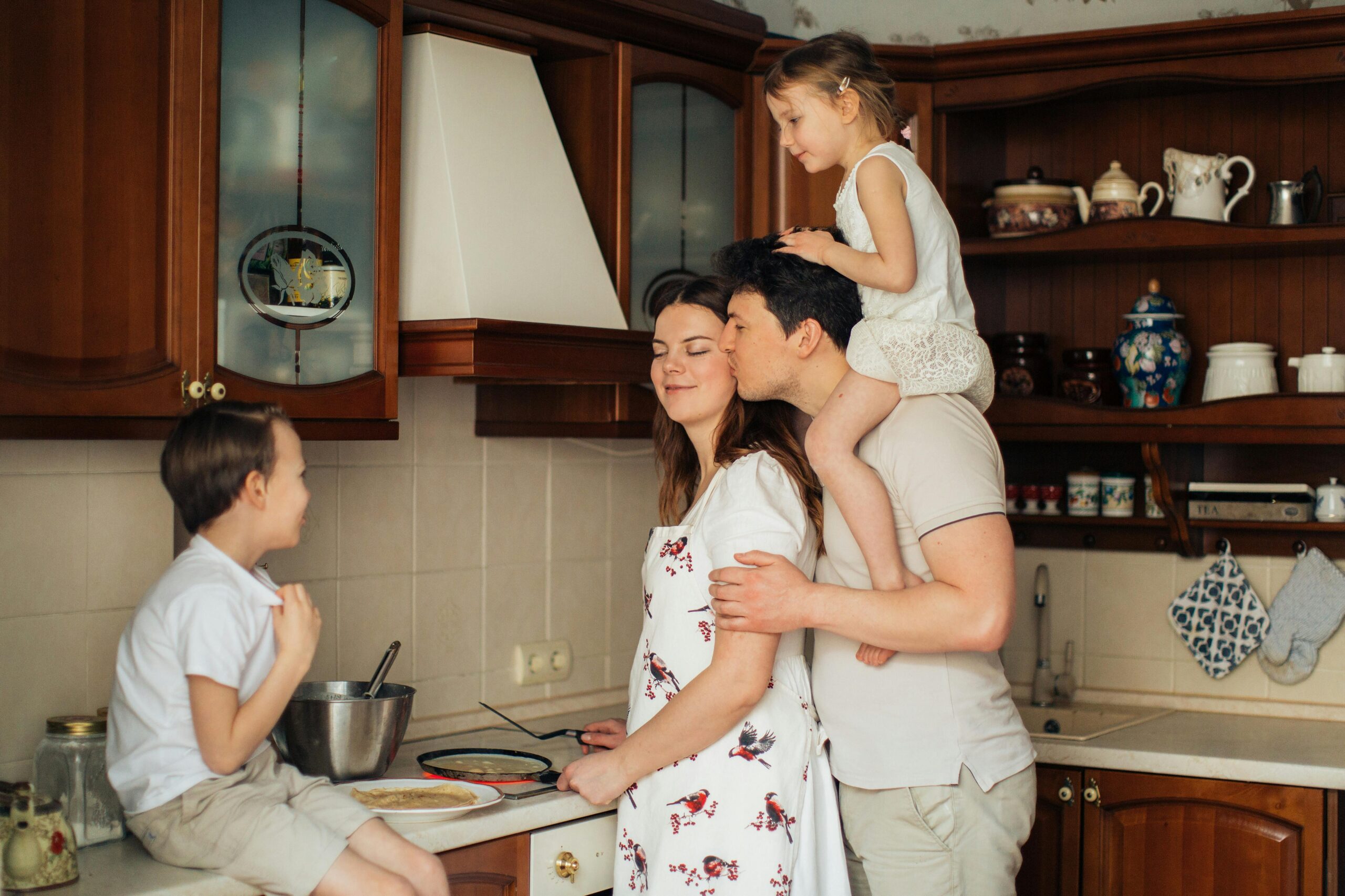 a family making food in the kitchen